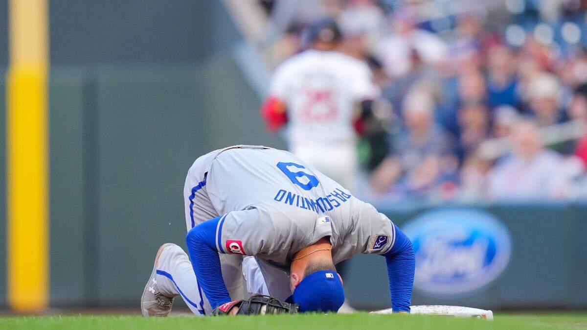 Kansas City Royals first base Vinnie Pasquantino (9) is injured trying to make the out at first against the Minnesota Twins outfielder Byron Buxton (25) in the third inning at Target Field on May 28, 2024.
