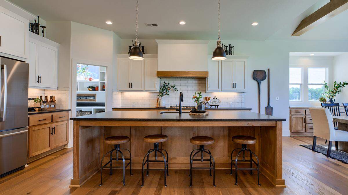 Rodrock is proud to offer more than 20 fabulously furnished models homebuyers can tour 7 days a week! Among them is the Emery II by James Engle Custom Homes in Stonebridge Park. Loaded with upgrades, this home boasts an open kitchen with an oversized island, walk-in pantry, and granite—while the nearby Great Room offers soaring ceilings and a see-through fireplace to a spacious covered patio.
