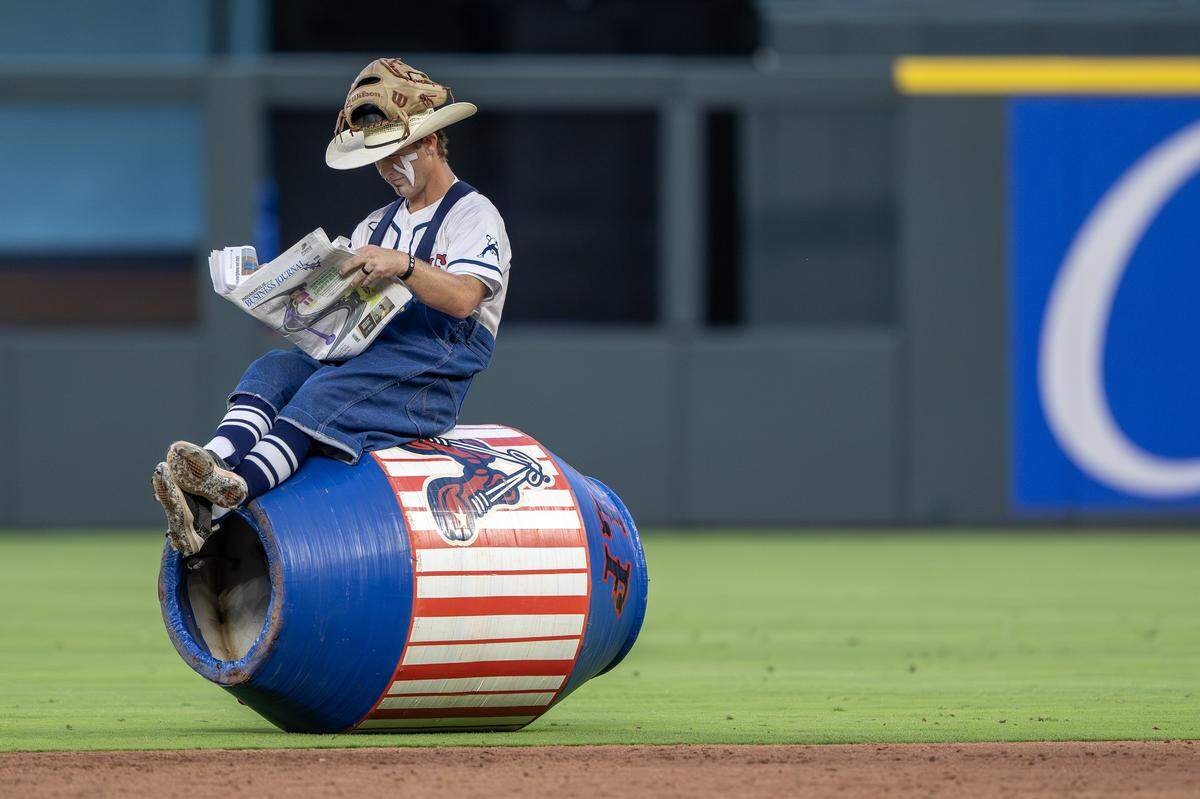 Indianapolis Clowns player Matt Wolf sits on a barrel during a Banana Ball game against the Savannah Bananas at Kauffman Stadium Saturday, May 30, 2026, in Kansas City.