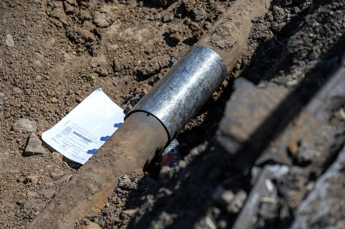 An underground gas pipe, secured with a new metal fitting, as seen on on Tuesday, April 15 alongside the site of a deadly Lexington, Mo., gas explosion on April 9, 2025. Gas lines were hit again on Sept. 25 and Sept. 26 in Lexington, but no injuries were reported.