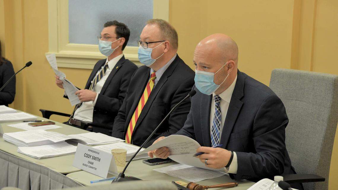 Missouri Rep. Cody Smith (right), a Carthage Republican, chairs a House Budget Committee meeting on March 22 with staff member Chris Dunn (center) and vice-chair Dirk Deaton, a Noel Republican.