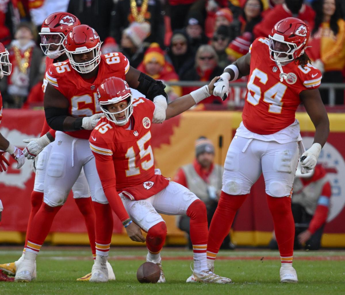 Kansas City Chiefs quarterback Patrick Mahomes (15) is pulled up by offensive tackle Wanya Morris (64) after being sacked by the Las Vegas Raiders defense on Friday, Nov. 29, 2024, at GEHA Field at Arrowhead Stadium.