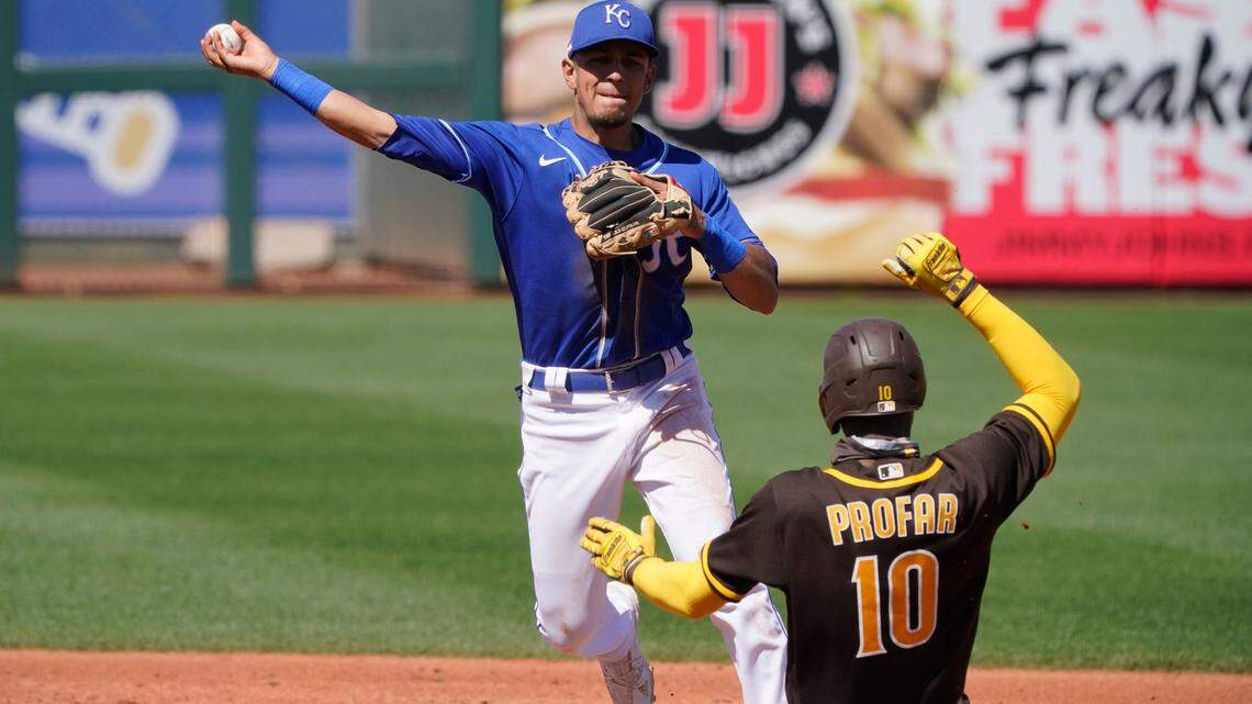 Kansas City Royals shortstop Nicky Lopez, left, throws to first base after forcing out San Diego Padres’ Jurickson Profar (10 on a double play ball hit by Eric Hosmer in the third inning of a spring training baseball game Monday, March 22, 2021, in Surprise, Ariz. (AP Photo/Sue Ogrocki)
