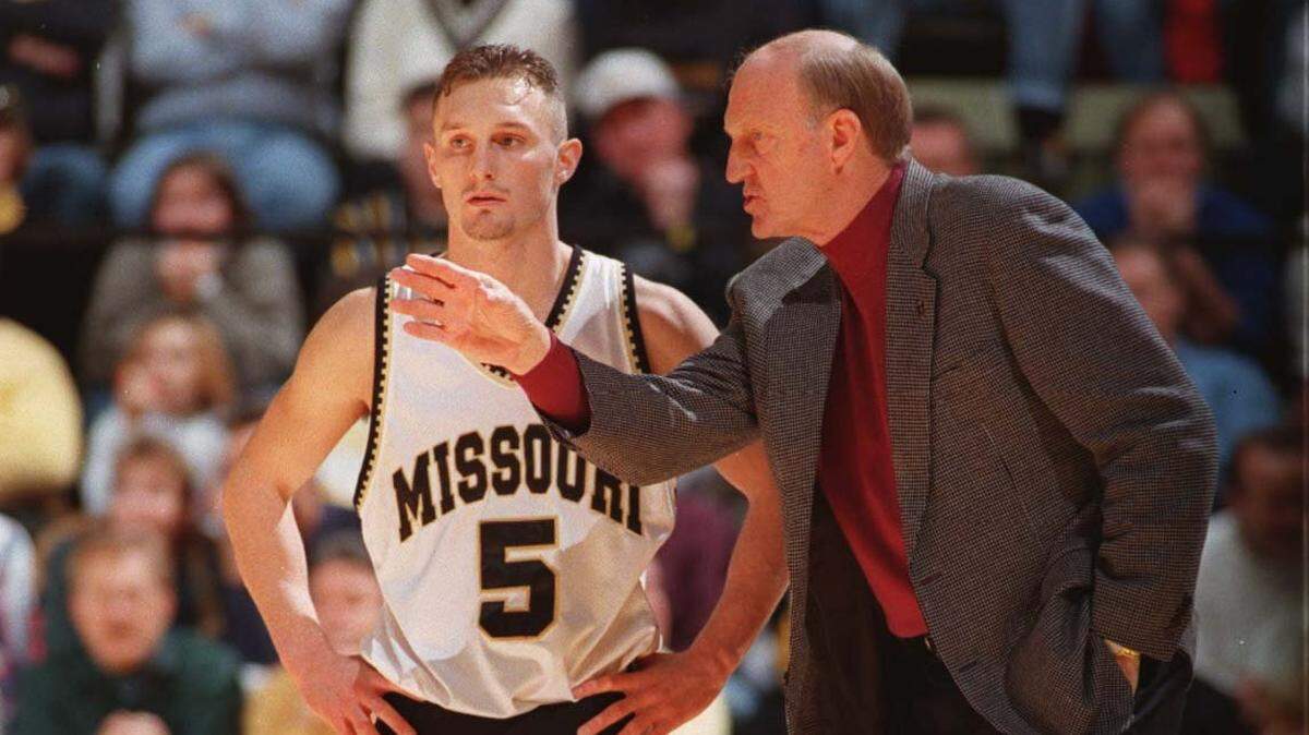 In this file photo, Missouri coach Norm Stewart (right) gives instructions next to Jason Sutherland. Stewart’s Tigers, led by Sutherland’s 18 points took down No. 1 Kansas on Feb. 4, 1997.