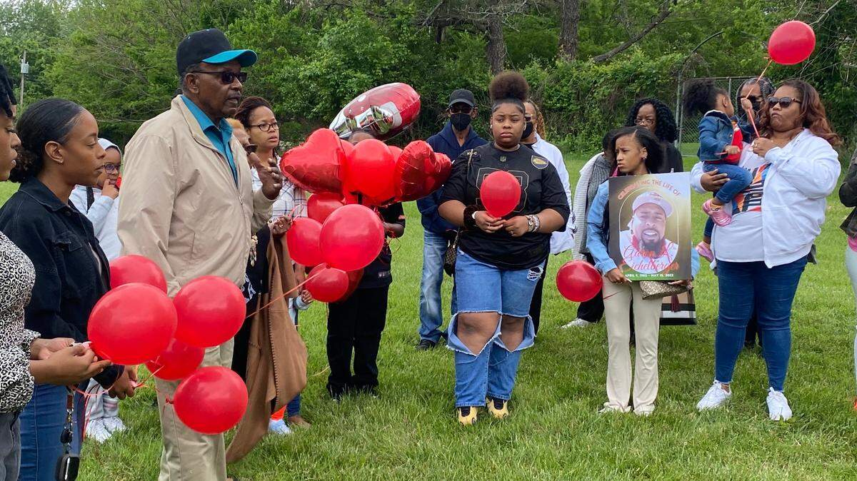 Aaron Eichelberger’s family, including his father, left, gathers at Maple View Park in south Kansas City for a balloon release in his memory. Eichelberger was fatally shot May 14 and found inside a crashed car at 88th Terrace and James A. Reed Road.