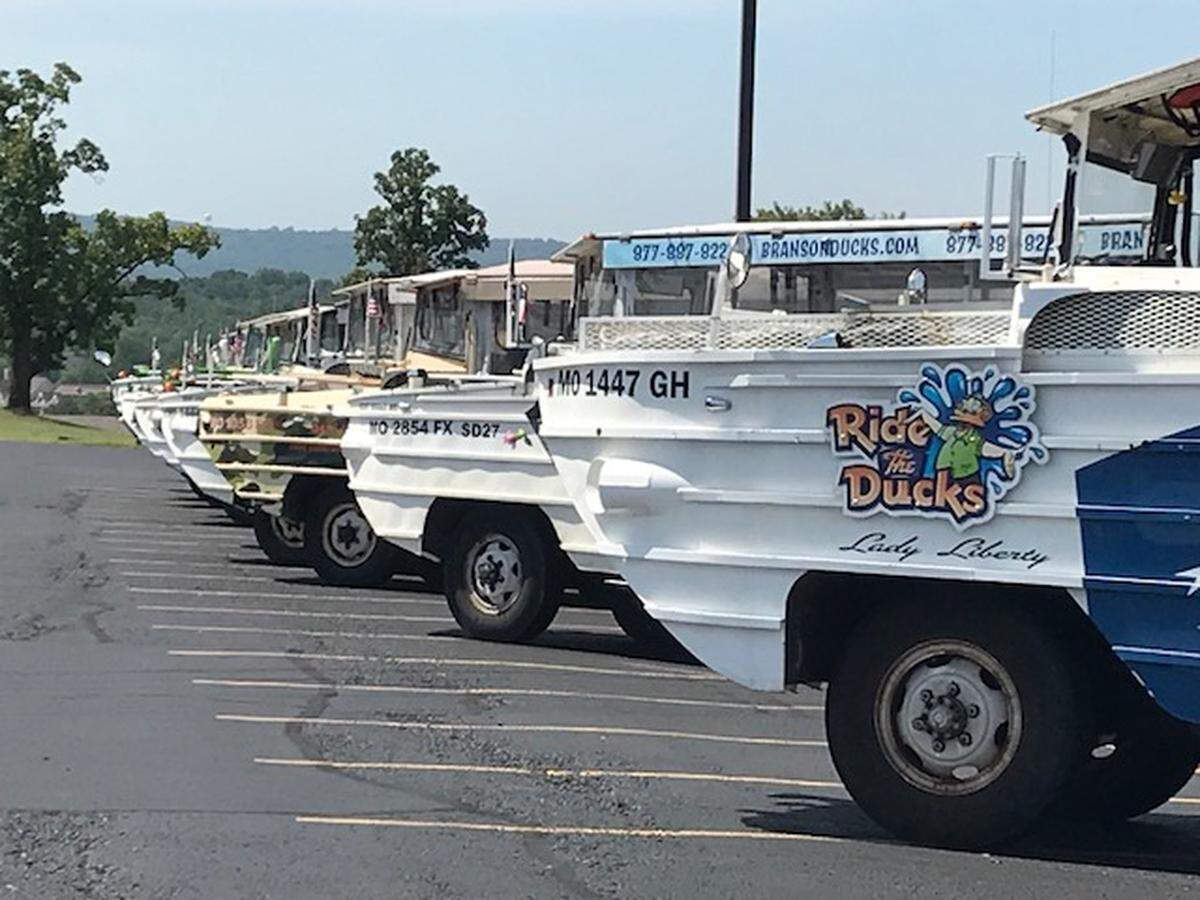 Duck boats lined up in the parking lot of Ride The Ducks attraction in Branson.