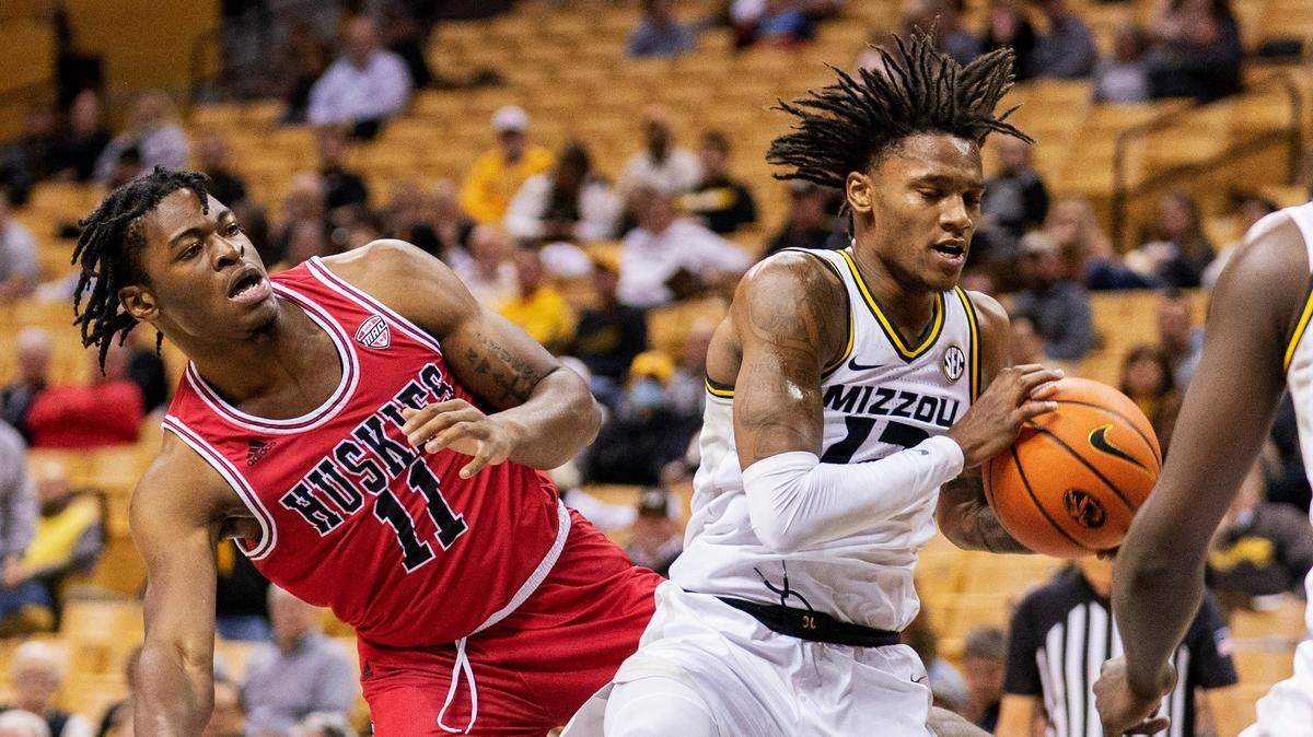 Missouri’s DaJuan Gordon, right, pulls down a rebound in front of Northern Illinois’s Chinedu Kingsley Okanu, left, during the first half of an NCAA college basketball game, Thursday, Nov. 18, 2021, in Columbia, Mo. (AP Photo/L.G. Patterson)