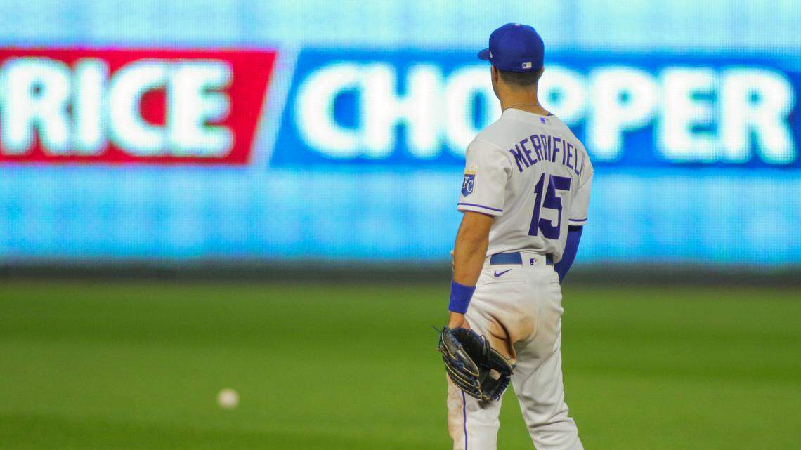 Kansas City Royals second baseman Whit Merrifield looks at the ball after it ricocheted off him for an error Saturday night against the Chicago White Sox at Kauffman Stadium. The Royals committed four errors on the night in their 11-5 loss.