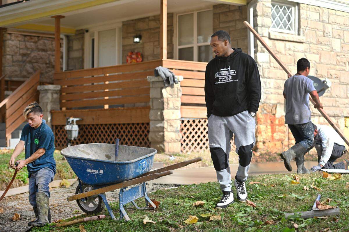 Sal Prewitt, a real estate investor and general contractor, looks on as one of his work crews pours concrete at a home he purchased and renovated in the 2800 block of Park Avenue on Kansas City’s East Side.