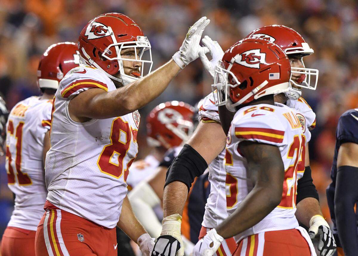 Kansas City Chiefs tight end Travis Kelce, 87, celebrated with teammates after scoring a two-yard touchdown pass reception from quarterback Patrick Mahomes in the fourth quarter against the Broncos in Denver. It was Mahomes’ 14th touchdown pass of the 2018 regular season.
