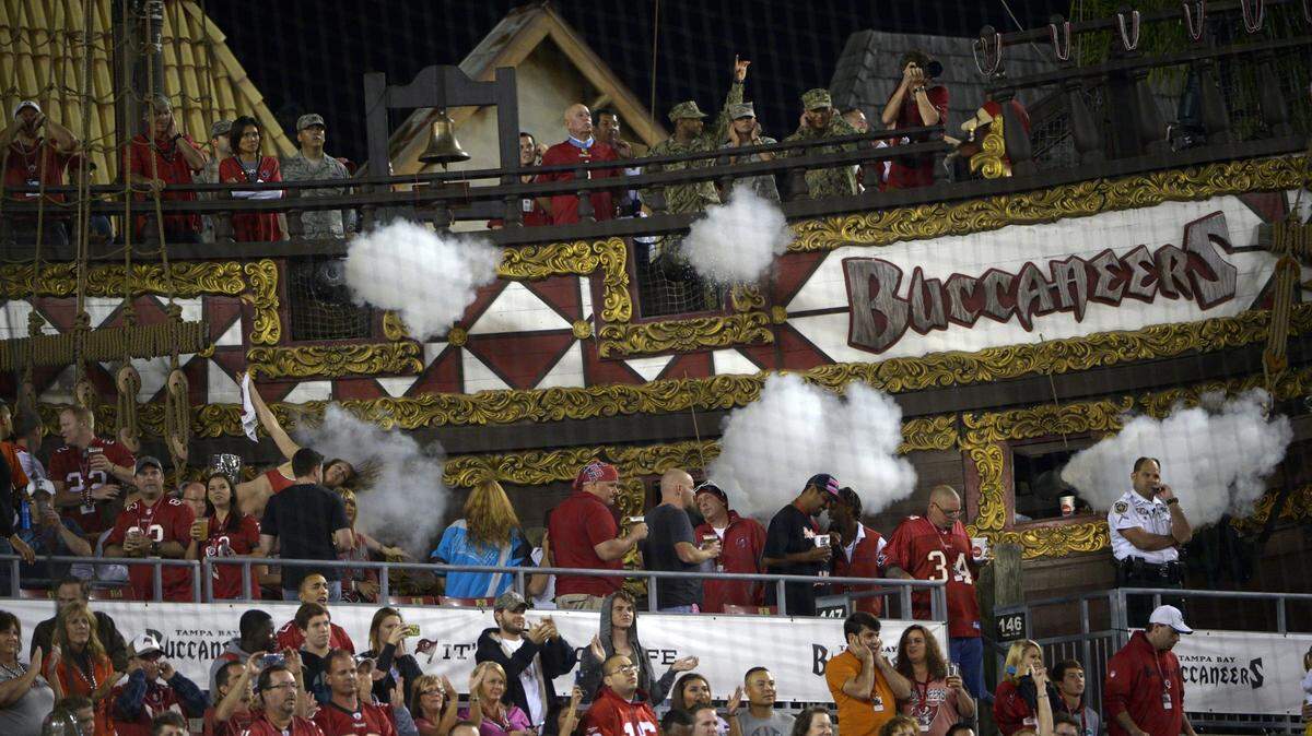 Smokes pours out of cannons fired from the Tampa Bay Buccaneers ship at Raymond James Stadium prior to an NFL football game against the Carolina Panthers in Tampa, Fla., Thursday, Oct. 24, 2013.(AP Photo/Phelan M. Ebenhack)
