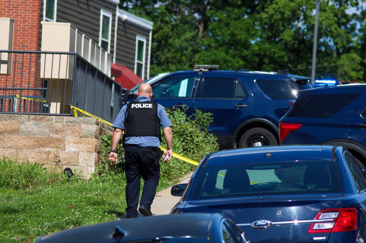 An officer arrives at the scene of a homicide in the 3400 block of Wyoming Street on Saturday.