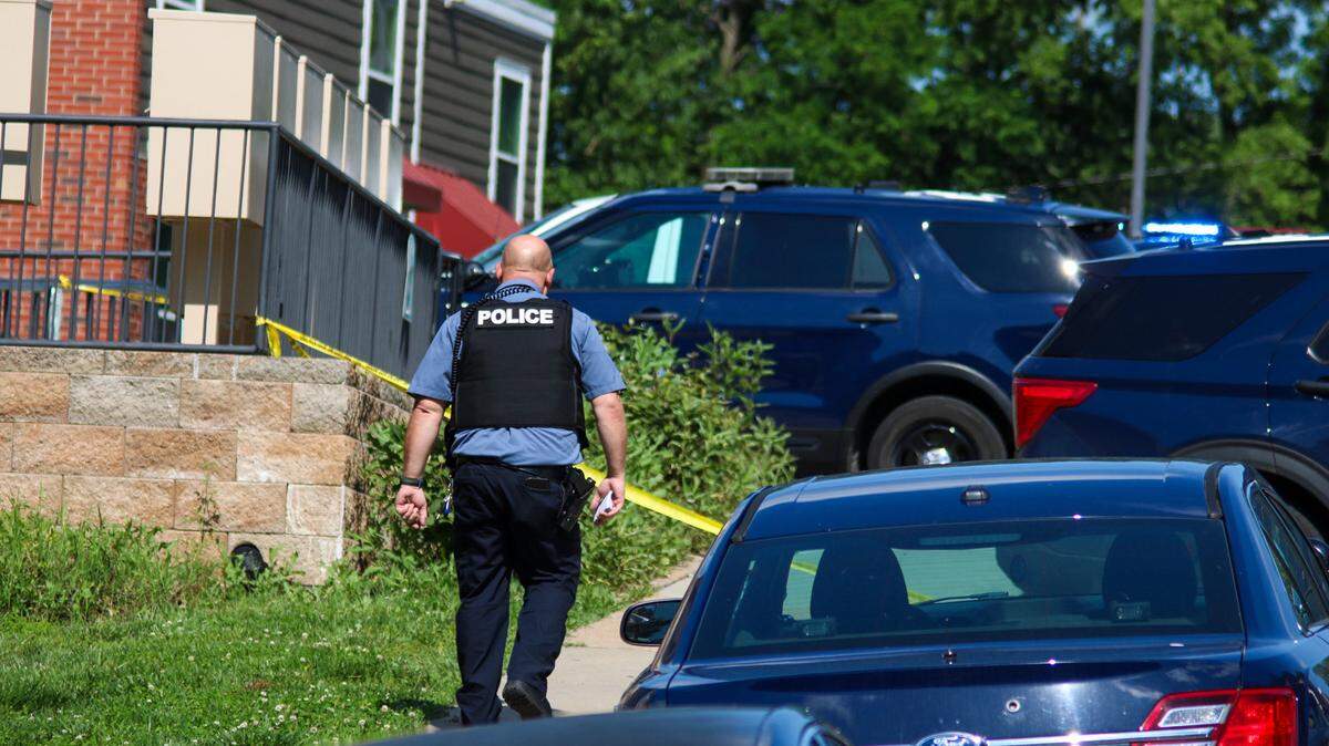 An officer arrives at the scene of a homicide in the 3400 block of Wyoming Street May 18, 2024. Police said multiple shots were fired after a call came in for a recovered stolen vehicle.