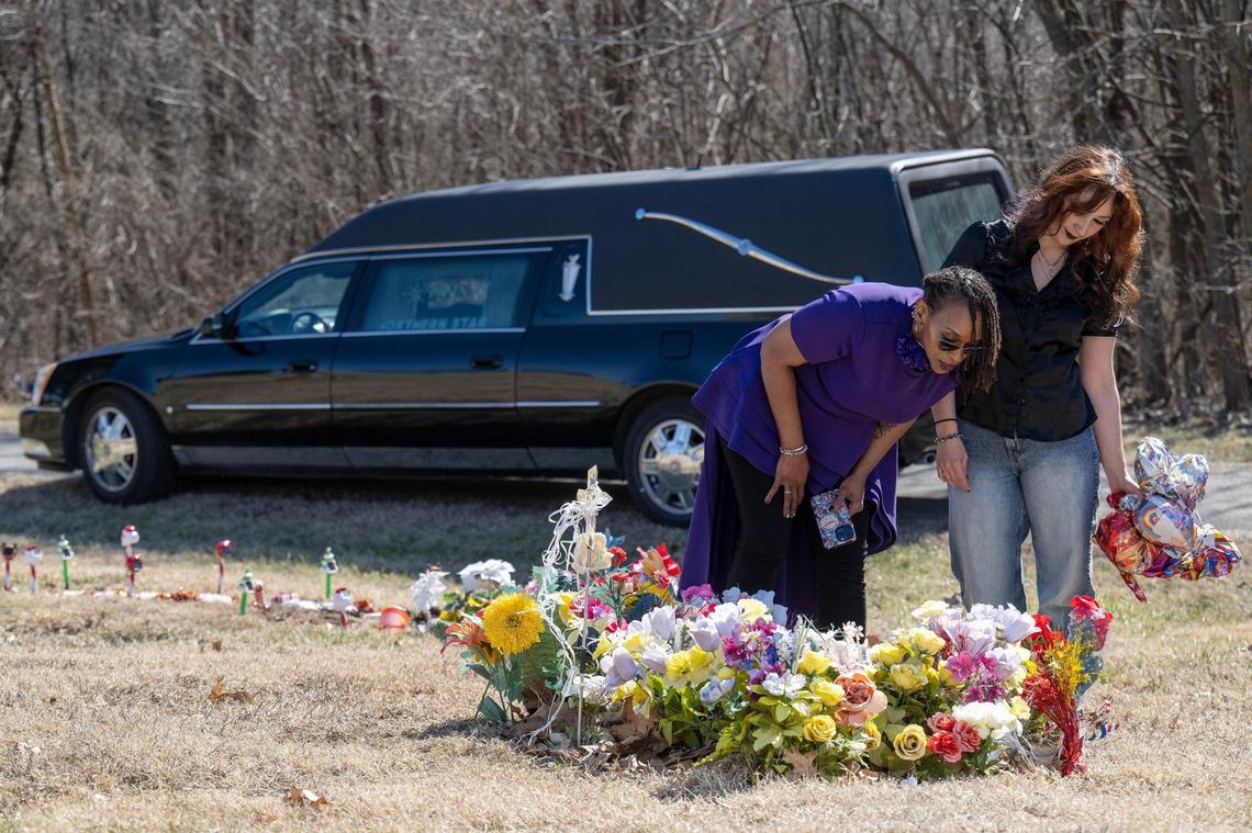 Gwendelrae Hicksand Abigail Cerrito, left, assistant funeral director, tidied up the the grave of a woman buried by Hicks in 2024 at Memorial Gardens in Kansas City, Kansas.