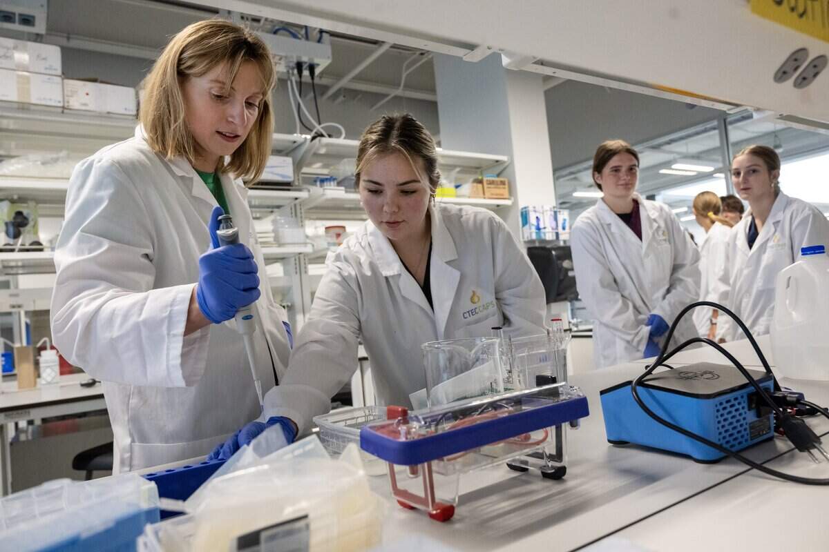 Olympic swimmer and Panasonic ambassador Katie Ledecky, left, visited Cedar Trails Exploration Center (CTEC) CAPS in Lenexa on Sept. 30, 2025, where she joined students Josi Kral, center, and Addison Gulley and others for a Bioscience lab experiment. Partnering with Panasonic, Ledecky met with De Soto School District students to share and learn in the STEM program.
