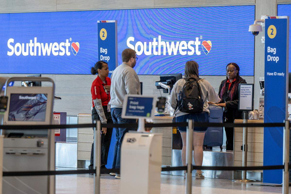 Associates from Southwest Airlines assist travelers at Kansas City International Airport on Wednesday, Feb. 28, 2024, in Kansas City.