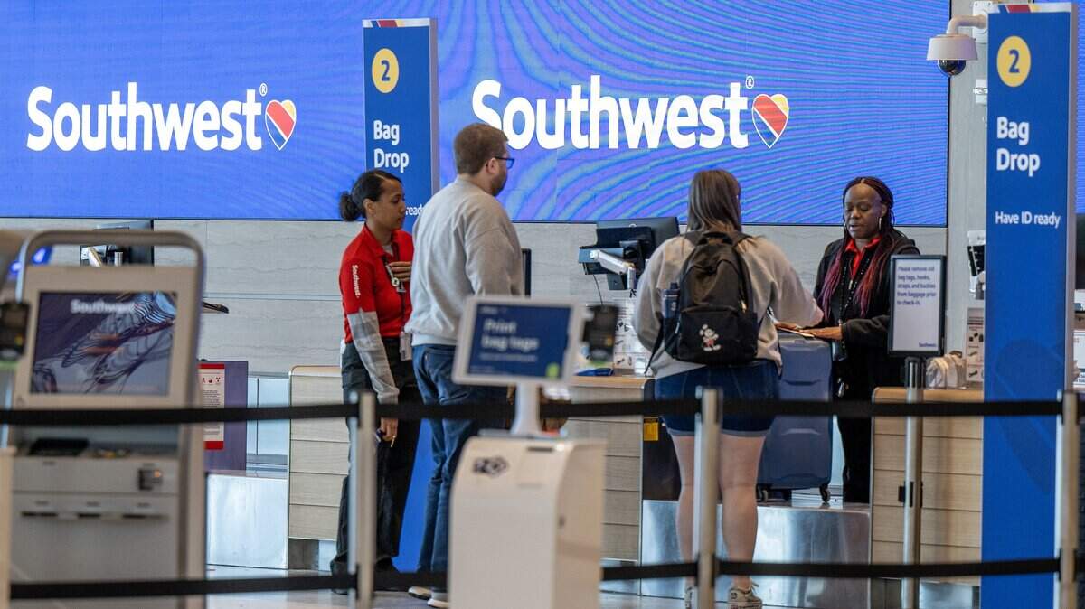 Associates from Southwest Airlines assist travelers at Kansas City International Airport on Wednesday, Feb. 28, 2024, in Kansas City.