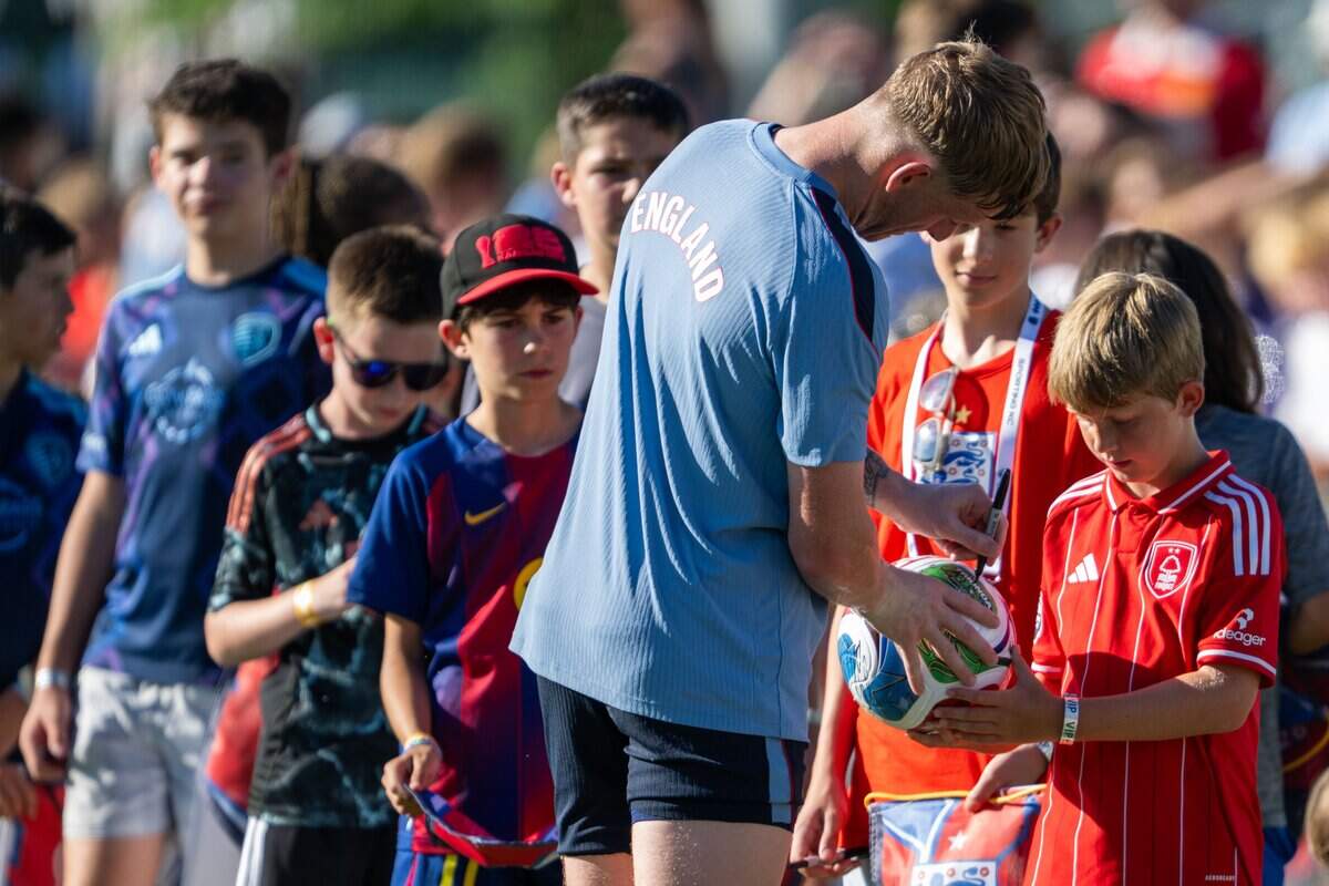 Players from England's national team sign autographs after practice at Swope Soccer Village, Saturday, June 13, 2026, in Kansas City. The team will call Prairie Village home during the World Cup.