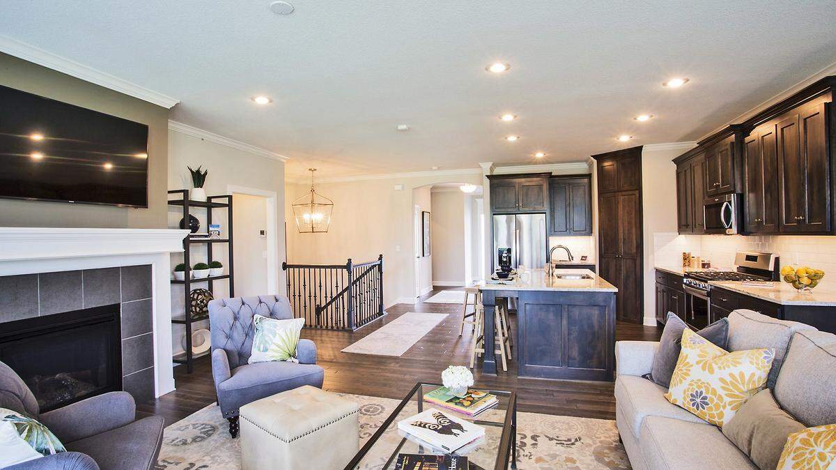 The chef-inspired kitchen, including gas stove-top and walk-in pantry, opens to the spacious living area, providing the perfect flow for effortless entertaining. Floor to ceiling windows provide beautiful views of Canyon Farms Golf Course.