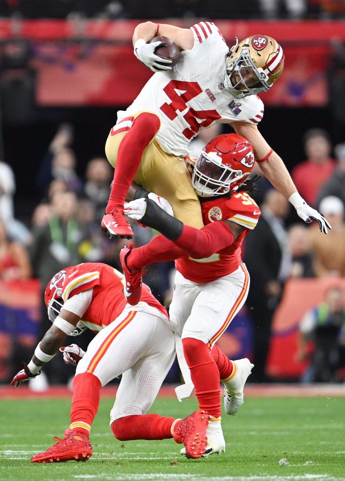 San Francisco 49ers fullback Kyle Juszczyk (44) tries to leap over Kansas City Chiefs linebacker Nick Bolton (32) in the first quarter of Super Bowl LVIII, Sunday, Feb. 11, 2024, in Las Vegas.
