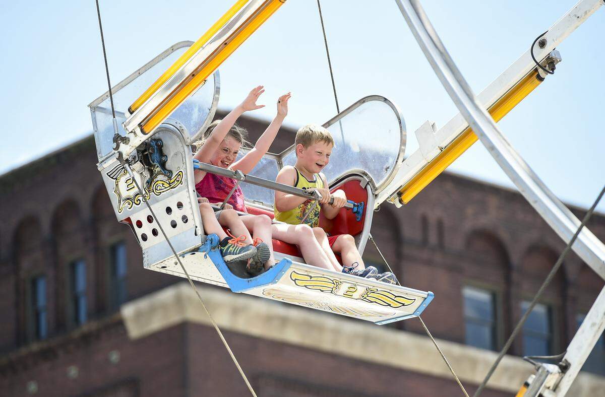 Cousins Molly Savage, of Iowa City, Iowa, and Sam Wiebers, of Trenton, Missouri, react to the Ferris wheel ride Saturday, June 18, 2016, at Boulevardia in Kansas City's West Bottoms.