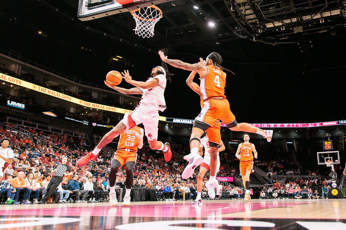 Arkansas Razorbacks point guard Boogie Fland drives to the bucket with basketball in hand during a men’s college game against the Illinois Fighting Illini at T-Mobile Center in Kansas City on Thanksgiving Day, Thursday, Nov. 28, 2024.
