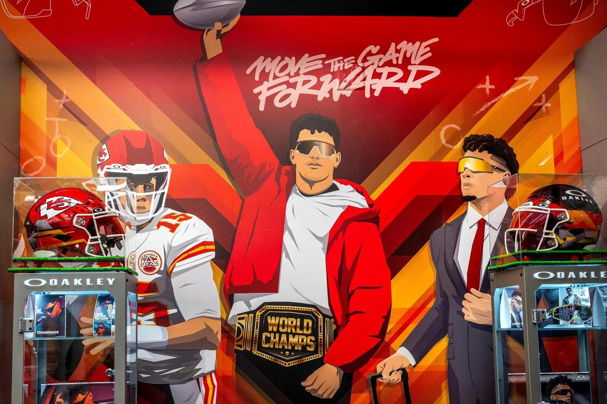 Sike Style Industries worked with Oakley NFL to make this Patrick Mahomes mural and Oakley-themed football helmets at the Chiefs Pro Shop at Arrowhead Stadium. Mahomes is a spokesperson for the Oakley glasses brand.