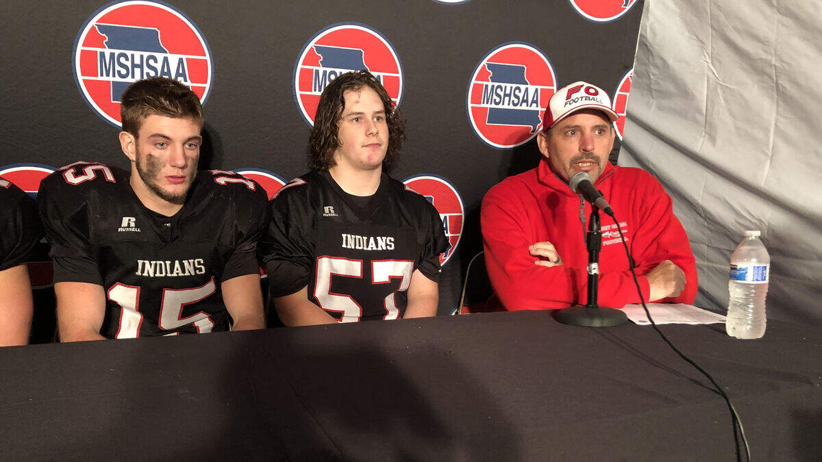 Fort Osage players (from left) Steven Orwick and Blake Murphy with coach Brock Bult after Fort Osage lost to Vianney 28-14 in the Missouri Class 5 final.