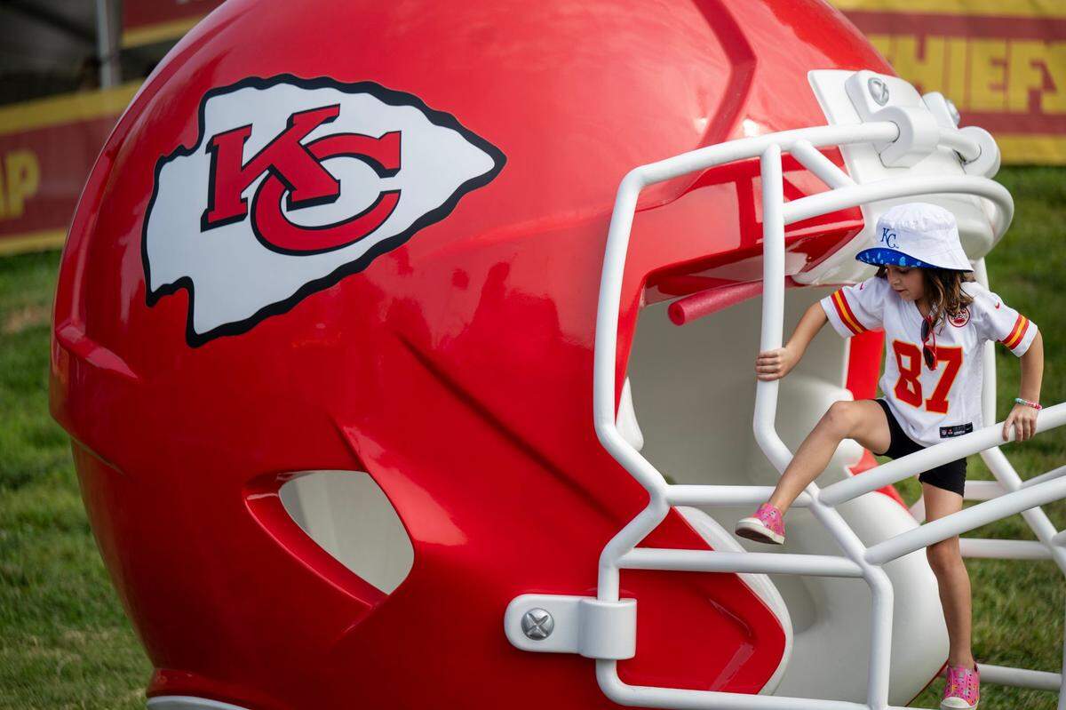 Waylan Hayes, 6, of St. Joseph, climbed the face mask of an over-sized helmet during a visit to Chiefs training camp. Hayes was at camp with her mother, Selena Hayes.