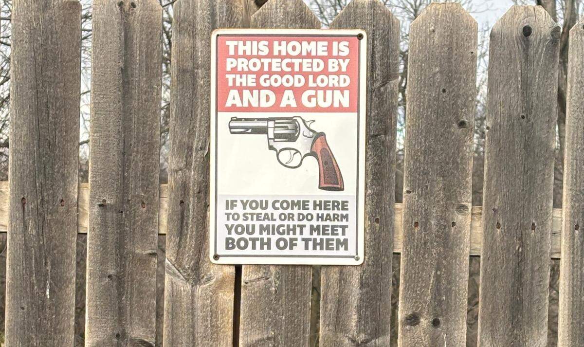 The fence surrounding John Thibeaux’s house in south Kansas City has a sign warning off criminals.
