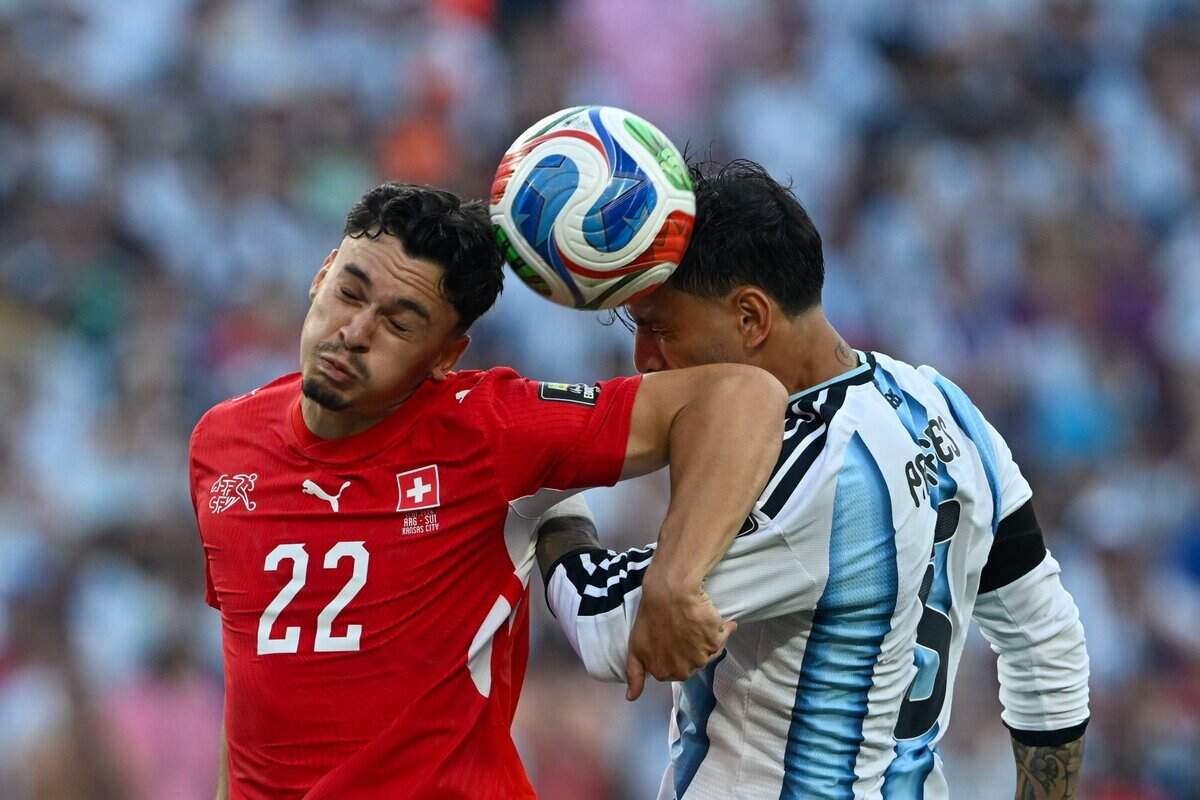 Switzerland midfielder Fabian Rieder (22) and Argentina midfielder Leandro Paredes (5) go up for a header to get the ball the play at the Argentina vs. Switzerland 2026 World Cup Quarterfinal football match at Kansas City (Arrowhead) Stadium in Kansas City on Saturday, July 11, 2026.