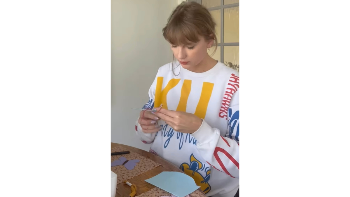 The one-of-a-kind University of Kansas sweatshirt Taylor Swift wore in a YouTube short video has inspired replicas.