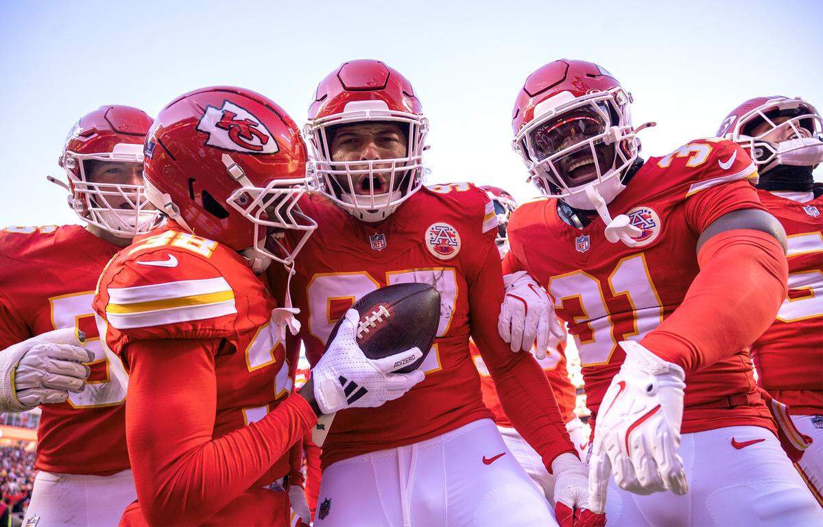 Kansas City Chiefs defensive end Ashton Gillotte (97) celebrates his interception withcornerback Kevin Knowles (38) and linebacker Jeffrey Bassa (31) during the first half on Sunday, Dec. 14, 2025 at GEHA Field at Arrowhead Stadium in Kansas City.
