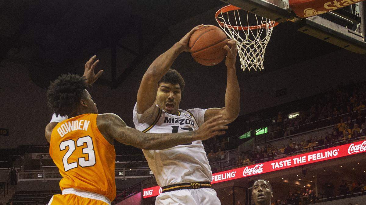Missouri’s Mark Smith, center, pulls down a rebound in front of Tennessee’s Jordan Bowden, left, during the second half of an NCAA college basketball game Tuesday, Jan. 8, 2019, in Columbia, Mo. Tennessee won the game 87-63. (AP Photo/L.G. Patterson)