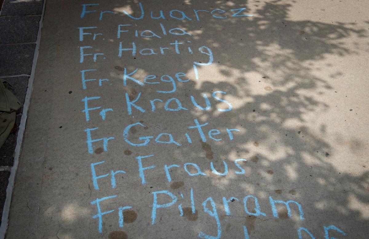 David Clohessy of SNAP, the Survivors Network of those Abused by Priests, wrote the names of priests credibly accused of sexual abuse down Wednesday, June 23, outside the Kansas City-St. Joseph Diocese, 20 W. 9th St., in Kansas City before a sidewalk press conference to denounce that the Diocese has failed to include nearly 20 priests on its list of clergy credibly accused of sex abuse even though they are named elsewhere.