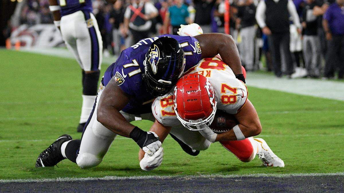 Kansas City Chiefs tight end Travis Kelce (87) scores a touchdown in front of Baltimore Ravens defensive tackle Justin Ellis (71) in the second half of an NFL football game, Sunday, Sept. 19, 2021, in Baltimore. (AP Photo/Nick Wass)