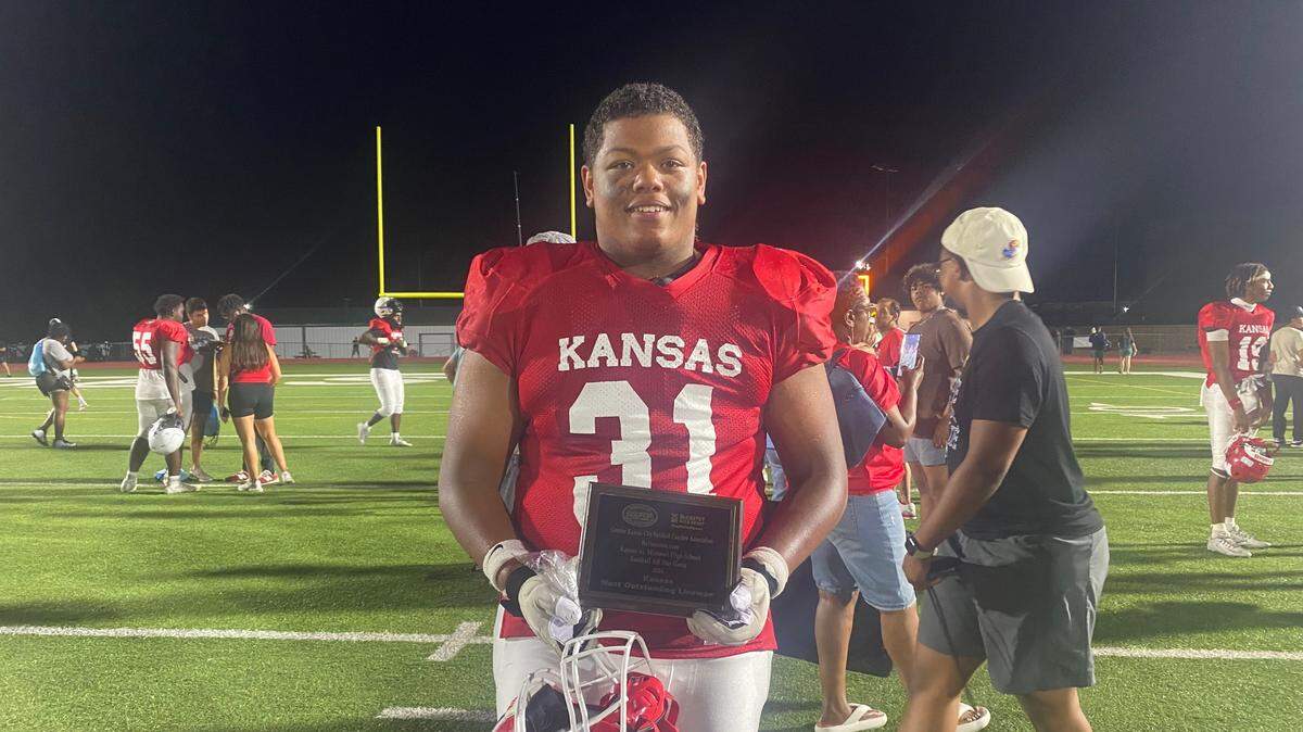 Kansas lineman Jalen Wilson holds his Outstanding Lineman award following the Kansas vs. Missouri All-Star Game on Friday, June 14, 2024.