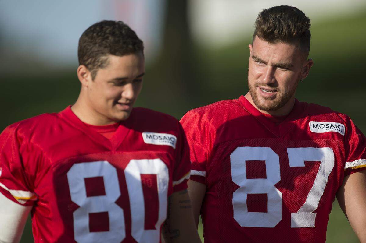 Kansas City Chiefs tight end Travis Kelce, right, walked to the field with fifth-round draft pick James O'Shaughnessy, left, during the team's training camp practice in 2015.
