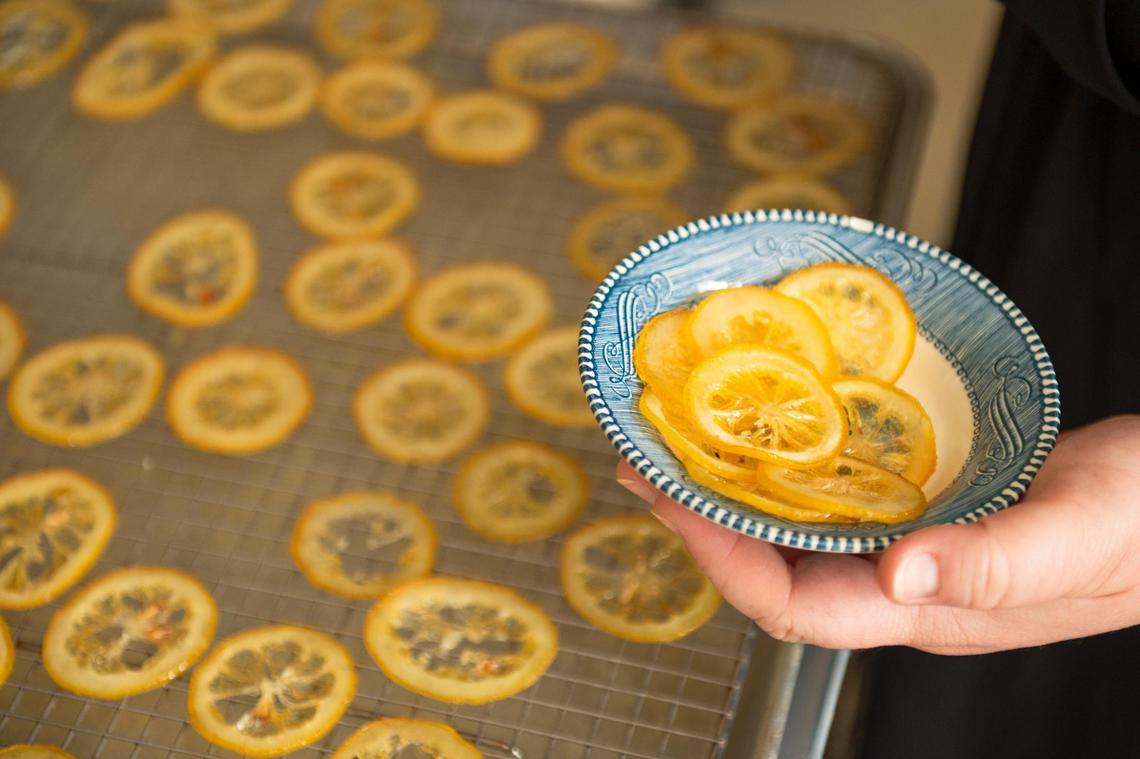 Lauren Snedden holds a bowl of candied lemons used to garnish the Clean crepe. Many customers don’t realize they’re edible and delicious.
