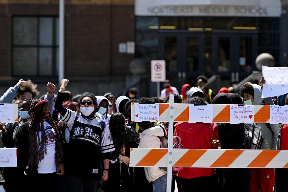 As family and friends of Manuel Guzman held a rally for justice outside Northeast Middle School, students joined them but were required to stand behind barricades.