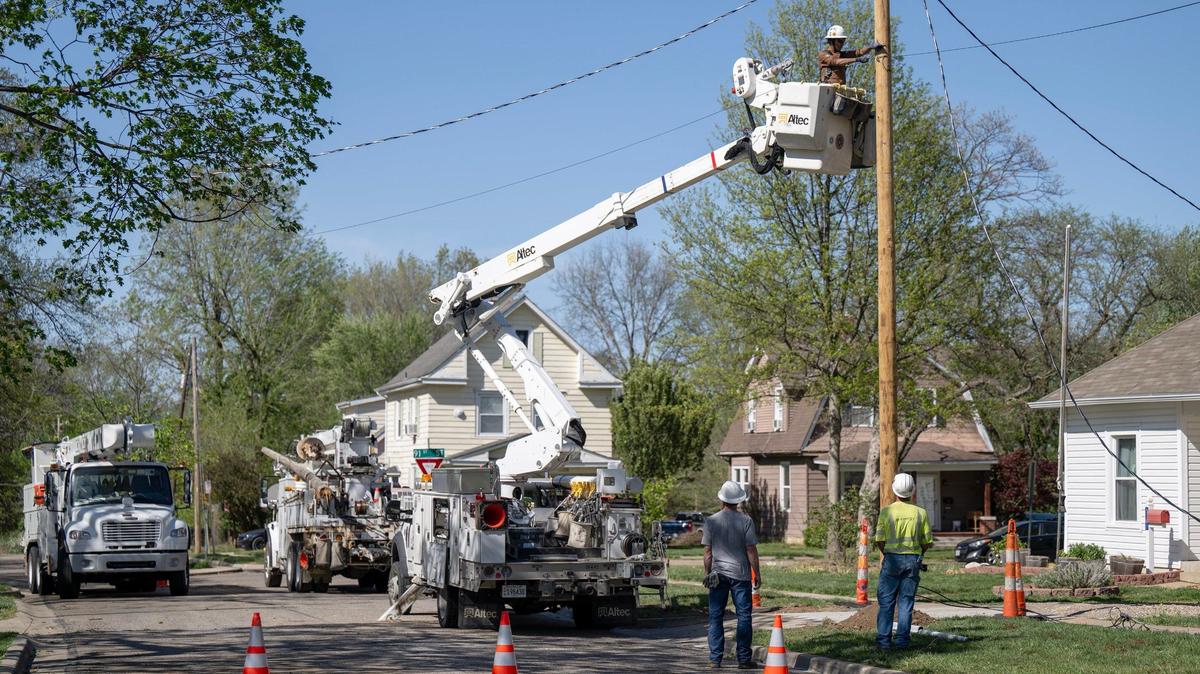 Linemen for Evergy worked to restore power to an area along 9100 Haskins St., in Lenexa, after a large tree fell and brought down the power lines during severe storms that moved through the area on April 16.