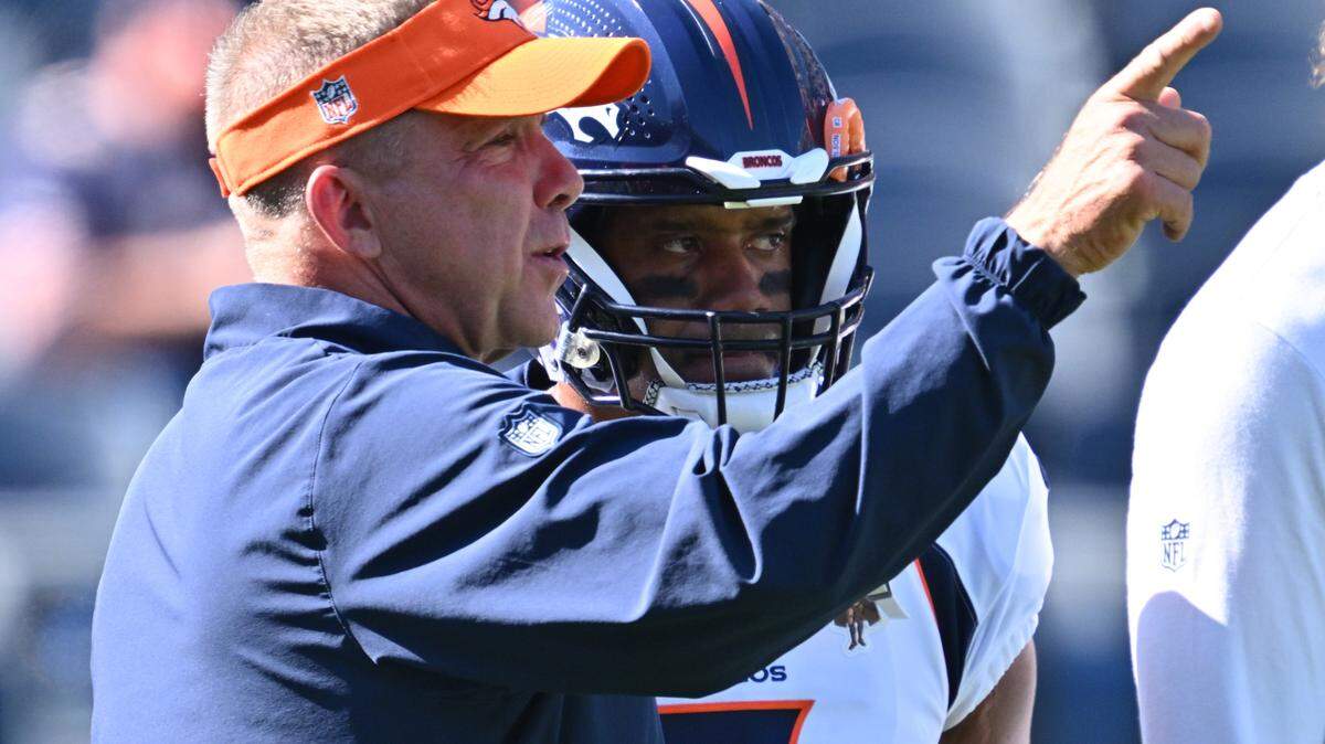 Denver Broncos head coach Sean Payton talks with quarterback Russell Wilson (3) before a game against the Chicago Bears at Soldier Field.