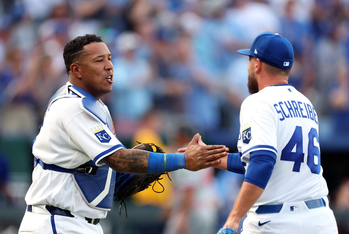 Kansas City Royals reliever John Schreiber is congratulated by catcher Salvador Perez as the Royals defeat the Minnesota Twins 3-1 to win the opening day game at Kauffman Stadium on March 30, 2026 in Kansas City, Missouri.