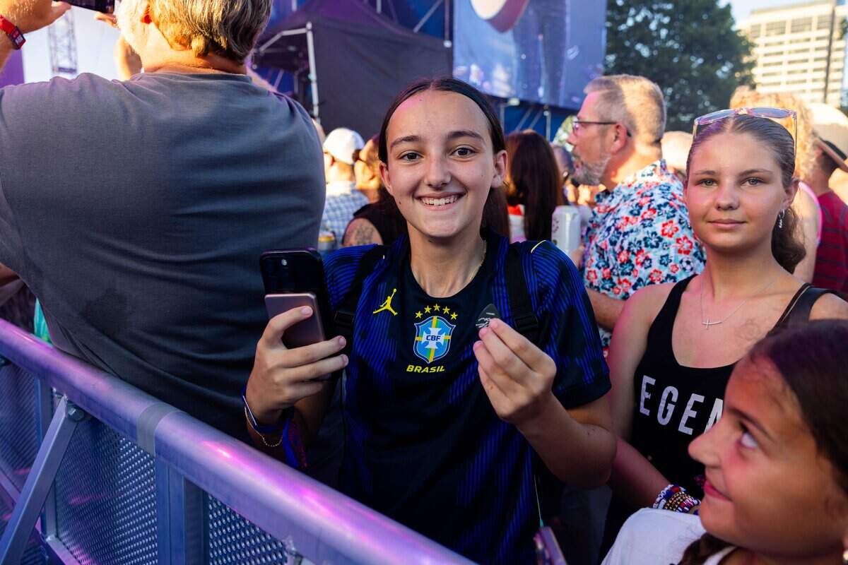 A member of the crowd shows off the guitar pick they received from Sheryl Crow during the FIFA Fan Fest concert at Fan Fest on Friday, July 10, 2026.