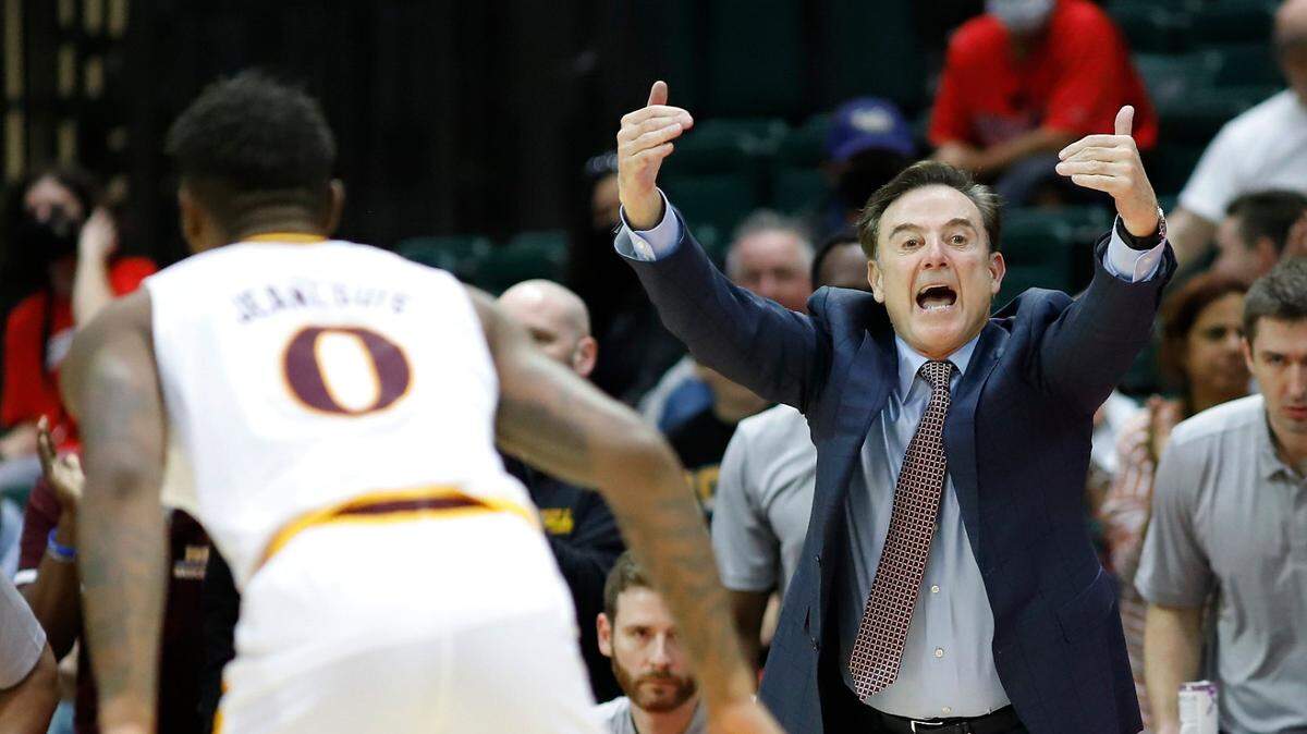 Iona guard Berrick Jeanlouis, left, guards an Alabama defender as Iona head coach Rick Pitino, right, yells to his team during the second half of an NCAA college basketball game Thursday, Nov. 25, 2021, in Orlando, Fla. (AP Photo/Jacob M. Langston)