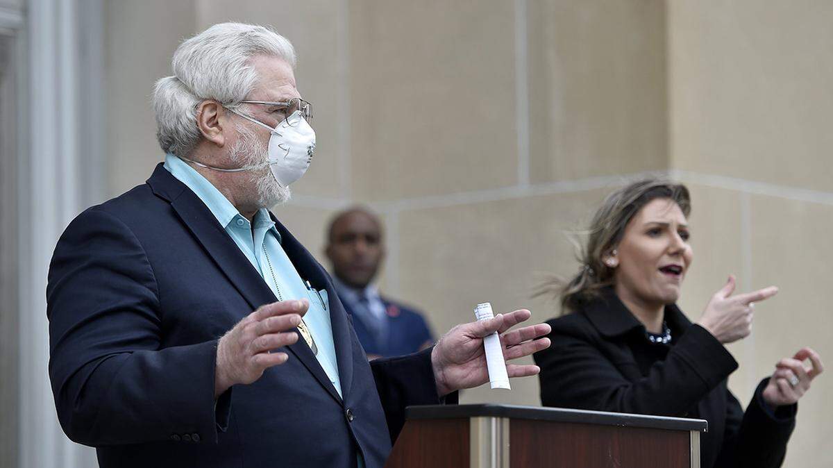 Health Department Director Rex Archer talks about the coronavirus situation in Kansas City at a press conference outside City Hall Thursday, Apr. 16, 2020. Mayor Quinton Lucas, center, talked about the extension of the stay-at-home order until May 15. Michelle DeMartino interpreted in sign language.