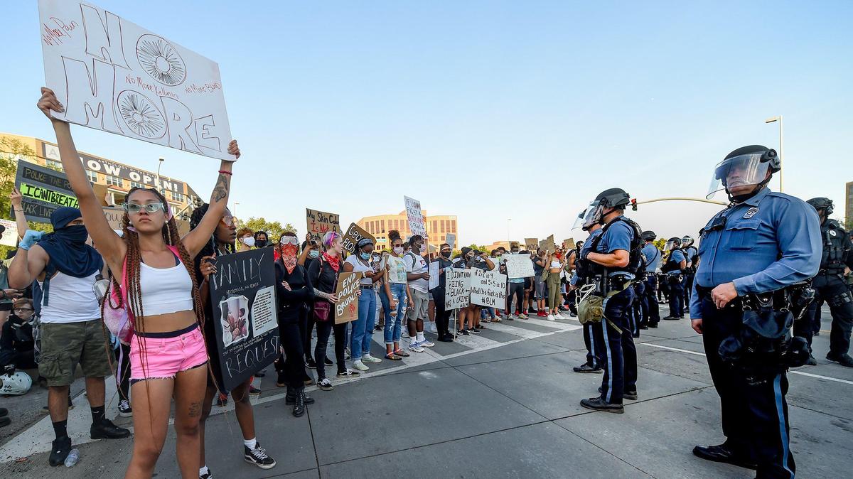 In front of a line of Kansas City Police, protesters gathered during a third day of protests Sunday, May 31, 2020, at the Country Club Plaza in Kansas City. Protests erupted all over the country after George Floyd, a Black man, was killed by Derek Chauvin on Memorial Day in Minneapolis.