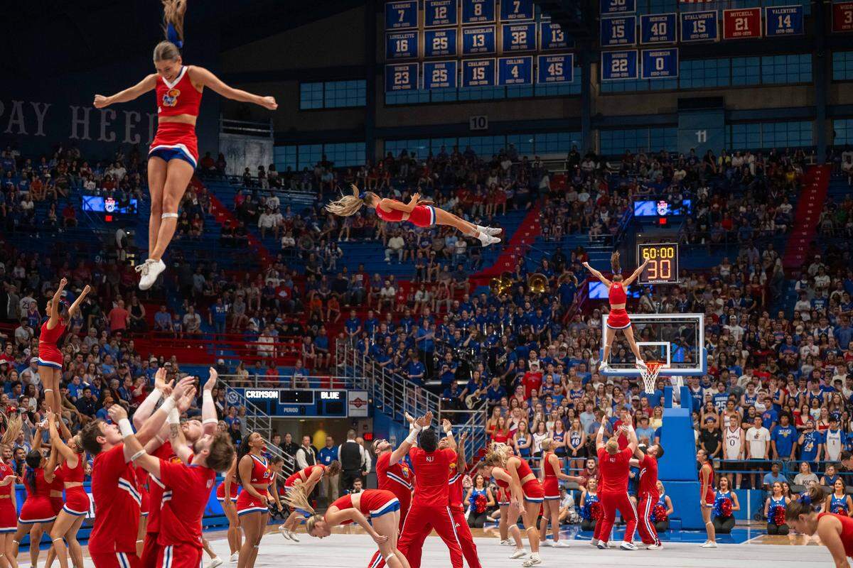 The Kansas Jayhawk cheerleaders perform acrobatics during Late Night in the Phog, on Friday, October 17, 2025, in Lawrence.