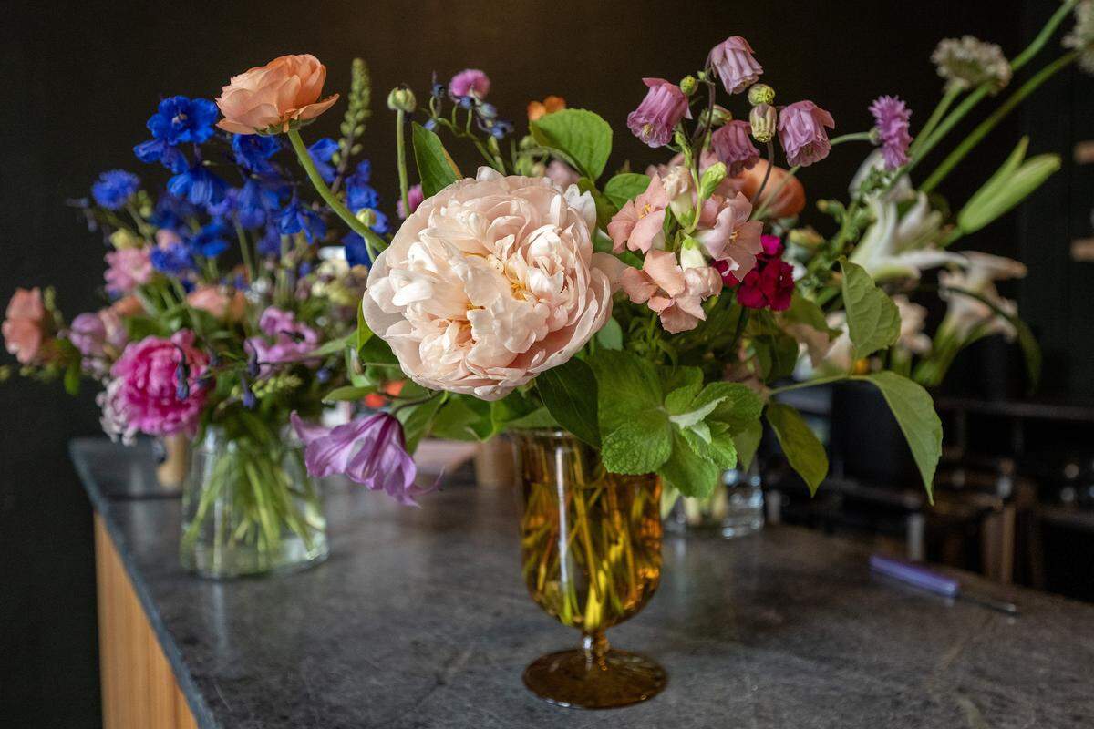 Bouquets of flowers are arranged in glass vases at Lily Floral Collective on Friday, May 8, 2026, in Kansas City.