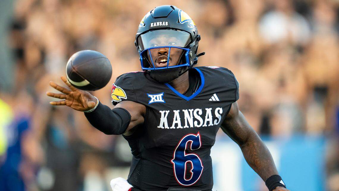 Kansas Jayhawks quarterback Jalon Daniels pitches the ball during the Illinois game at David Booth Kansas Memorial Stadium.